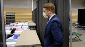Brett Peppin, director of environmental health with Boone County Health Department, looks beds set-up in a building at the Boone County 4-H Fairgrounds to handle COVID-19 patients, Monday, April 6, 2020, in Lebanon, Ind. The new coronavirus causes mild or moderate symptoms for most people, but for some, especially older adults and people with existing health problems, it can cause more severe illness or death.