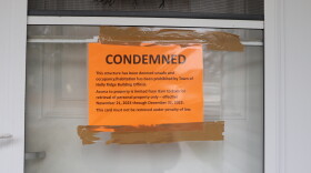A close up shot of an orange notice posted on one Holly Plaza apartment's front door. The notice reads: "CONDEMNED. This structure has been deemed unsafe and occupancy/habitation has been prohibited by Town of Holly Ridge Building Official. Access to property is limited from 8 a.m. to 8 p.m. for retrieval of personal property only -- effective November 21, 2023 through December 31, 2023. This card must not be removed under penalty of law."