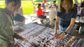 Volunteers weave sleeping mats during the Day of Service.