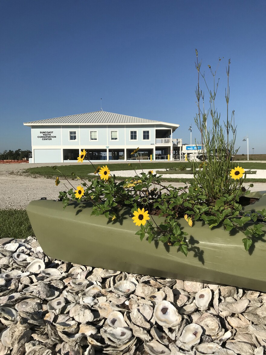  Recycled oyster shells, native Florida plants and a repurposed kayak sit at the entrance of the Suncoast Youth Conservation Center 