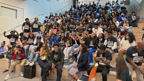 Rising hip-hop star La Reezy poses with students at New Orleans Charter Science and Mathematics High School on May 1, 2026