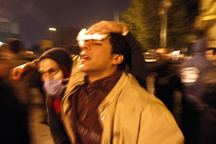 A paramedic helps a wounded demonstrator in Cairo's Tahrir Square on Wednesday.