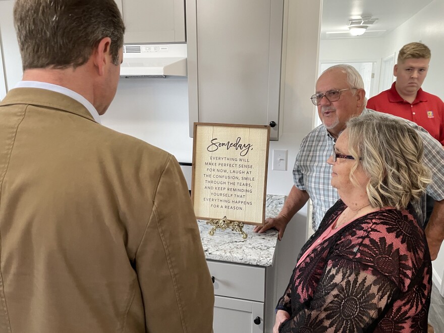 Billy and Barbara Patterson (right) speaking with Gov. Andy Beshear inside their new home.