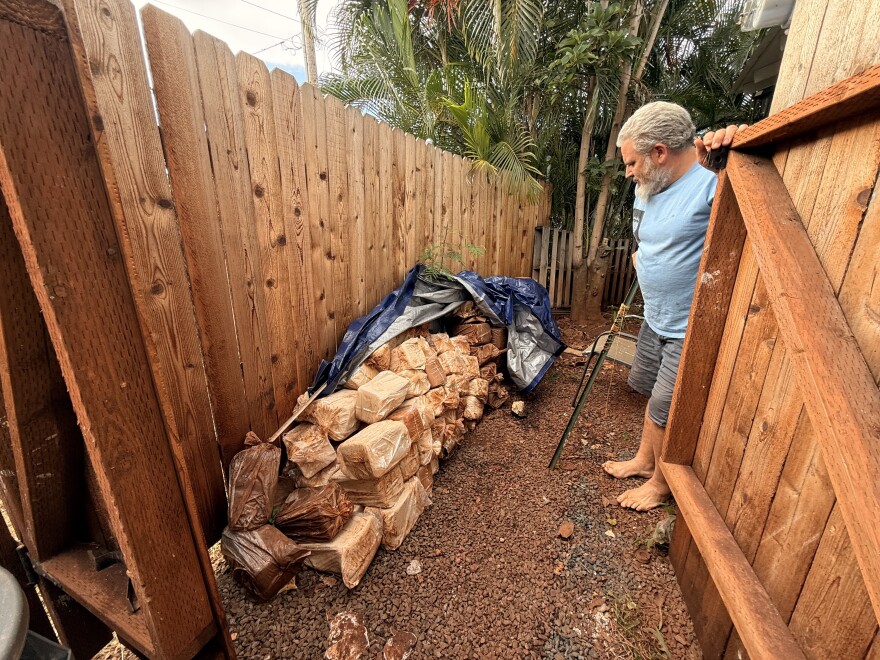Matt Pearce overlooks his bags of clay that are covered in red