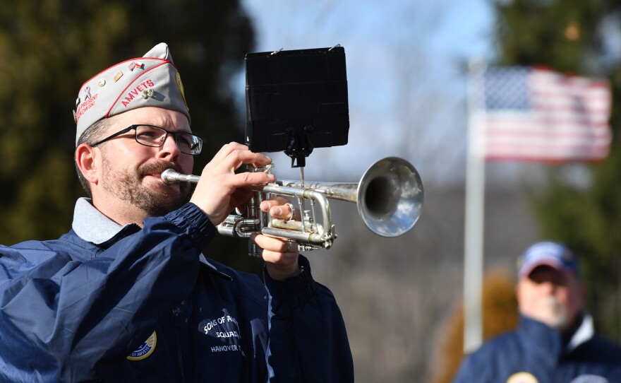 Mike Truszkowski, a bugler from the AMVETS 59 of Hanover Township, played a song for each branch of the military as wreaths were presented.