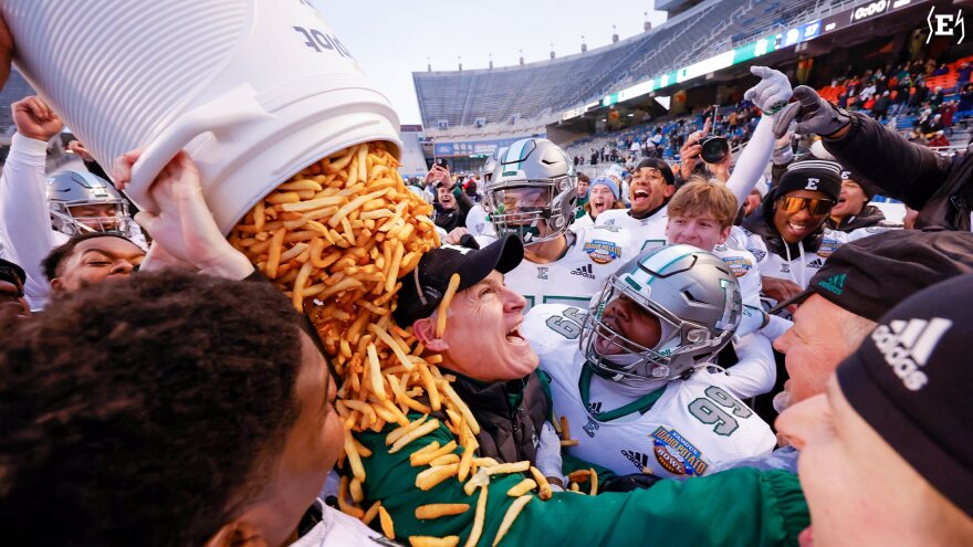 Eastern Michigan head coach Chris Creighton is showered with french fries after the Eagles beat San Jose State 41-27 to win the 2022 Famous Idaho Potato Bowl in Boise, Idaho