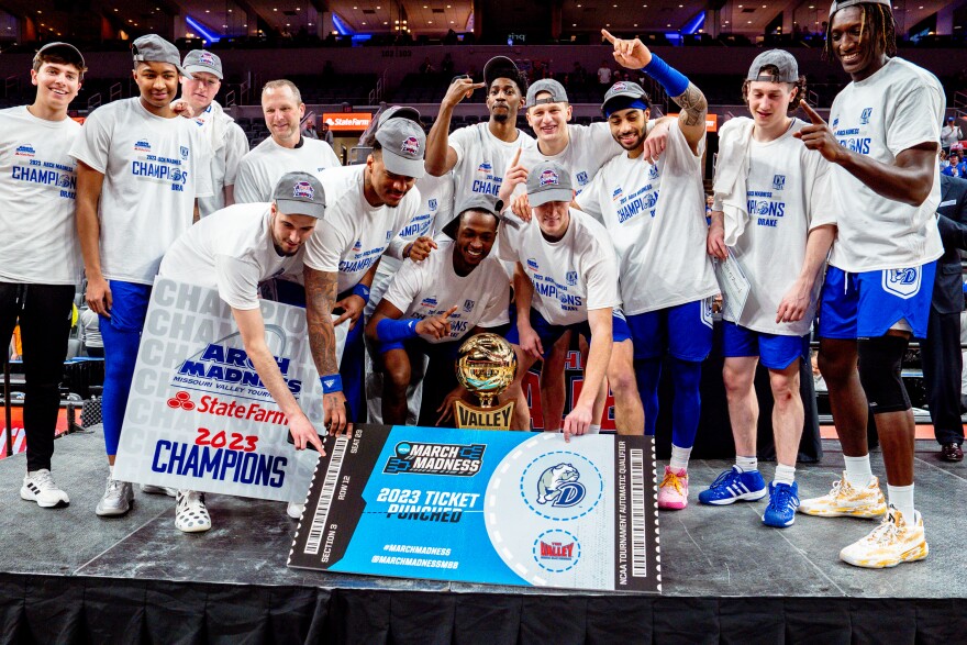 Members of the Drake Bulldogs team celebrate winning the the Missouri Valley Conference’s “Arch Madness” championship against the Bradley Braves and punching their ticket to the national March Madness tournament on Sunday, March 5, 2023, at the Enterprise Center.