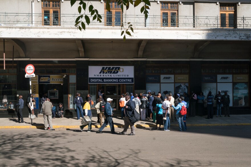 People line up to use an ATM at NMB bank in Harare.