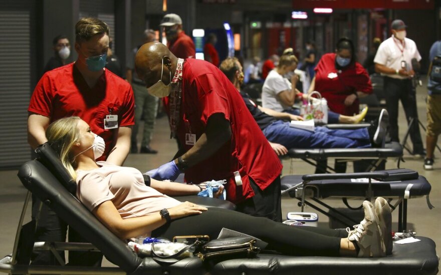 People donate blood during a Red Cross and Arizona Diamondbacks baseball team blood drive at Chase Field Tuesday, April 28, 2020, in Phoenix. According to the Red Cross, as of April 5, nearly 14,000 Red Cross blood drives have been canceled across the country due to coronavirus concerns, resulting in more than 400,000 fewer blood donations.(AP Photo/Ross D. Franklin)