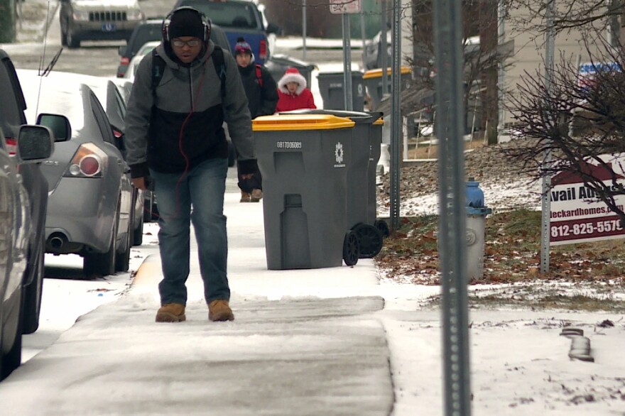 Bloomington residents walk through snow and ice. (Photo: WTIU News)