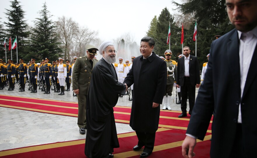 Iranian President Hassan Rouhani greets visiting Chinese President Xi Jinping at the Saadabad Palace in Tehran on Saturday. With sanctions lifted, the countries pledged to develop economic ties.