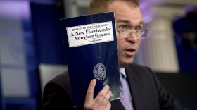 In this May 23, 2017, photo, budget director Mick Mulvaney holds up a copy of President Donald Trump's proposed fiscal 2018 federal budget as he speaks to members of the media in the Press Briefing Room of the White House in Washington. His $4.1 trillion plan for the budget year beginning Oct. 1 generally proposed deep cuts in safety net programs, including Medicaid and the Children's Health Insurance Program. (Andrew Harnik/AP)
