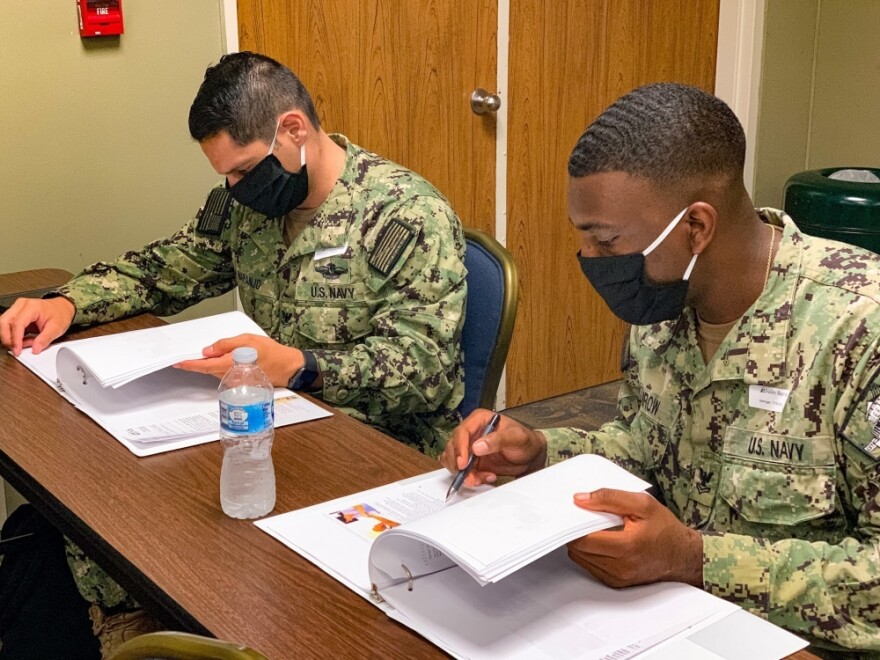 U.S. Navy Hospital Corpsman 2nd Class Ryon Kumrow (right) and Jose Naranjo (left), advanced radiology technologists from Naval Hospital Pensacola, review training material during orientation at Valley Baptist Medical Center- Harlingen.