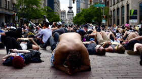 Protestors, calling for an end to police brutality and racial injustice, stage a die-in outside the City-County Building in downtown Indianapolis.