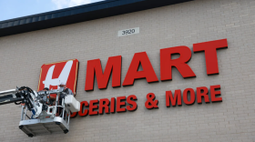 Workers put up the H Mart letters Sept. 18 in Haltom City.