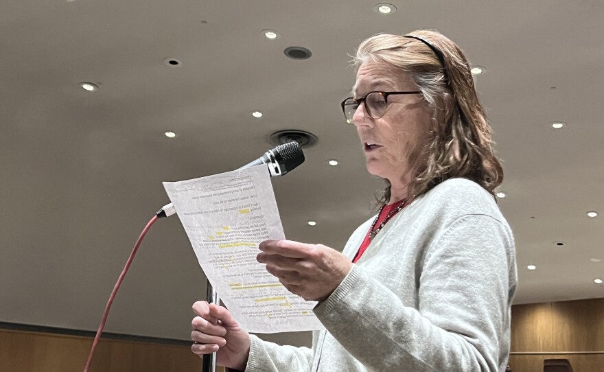 Hibbing community member Molly Johnsrud offers suggestions like renting space or selling a portion of the city block to prevent the closure of Greenhaven Elementary School at a March 26, 2026, public hearing at Lincoln Middle School in Hibbing.