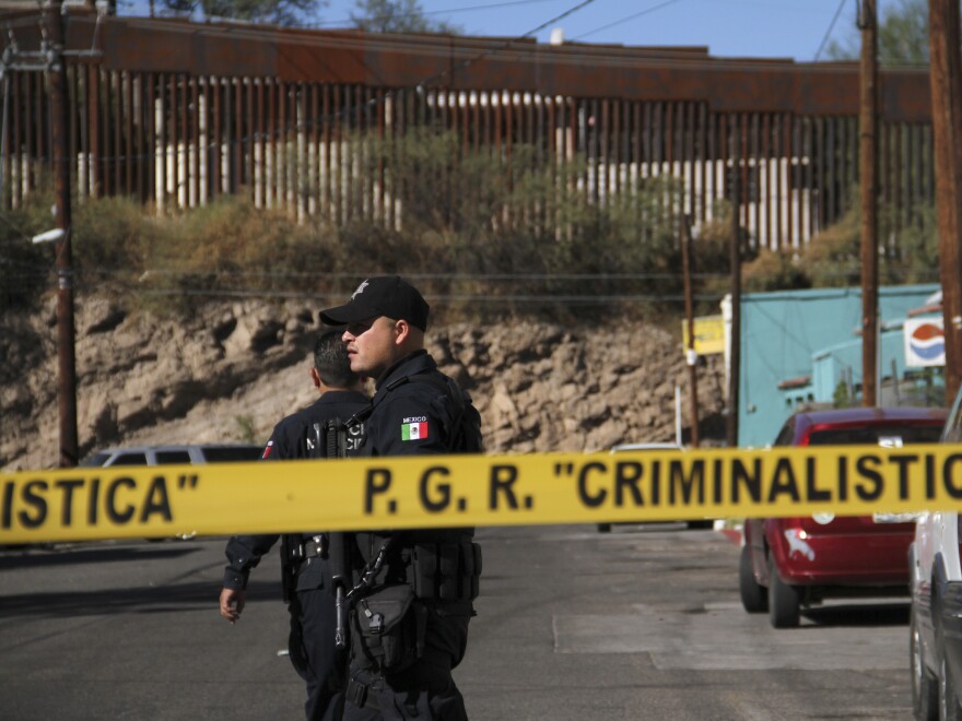 An investigator inspects a crime scene where a 16-year-old was shot. At least one U.S. Border Patrol agent shot into Mexico after rocks were thrown at him, hitting the teen.