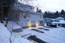 FILE - Bare spots are seen, Nov. 29, 2022, in the snowy parking lot in front of the home where four University of Idaho students were found dead on Nov. 13, in Moscow, Idaho, after vehicles belonging to the victims and others were towed away earlier in the day. Objections have been raised to demolishing the house where four University of Idaho students were killed in 2022, with members of three of the victims' families signaling it should be preserved until after the trial of the man charged in the deaths.