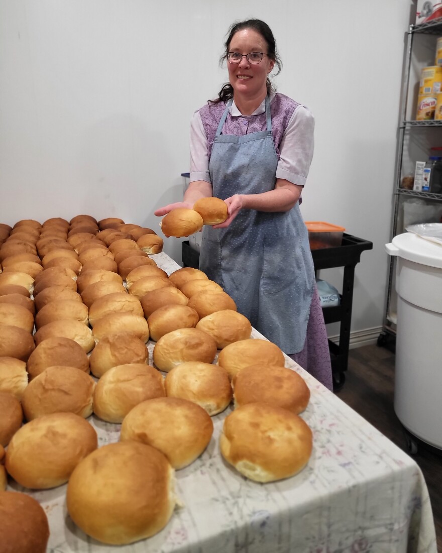 Baker Christy Wickhorst shows off the house made hamburger rolls that just came out of the over. The recipe comes from her Hutterite upbringing.