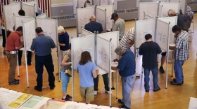 Residents cast their vote at a polling station at the Kennebunk Town Hall in Kennebunk, Maine, Tuesday, June 12, 2018.