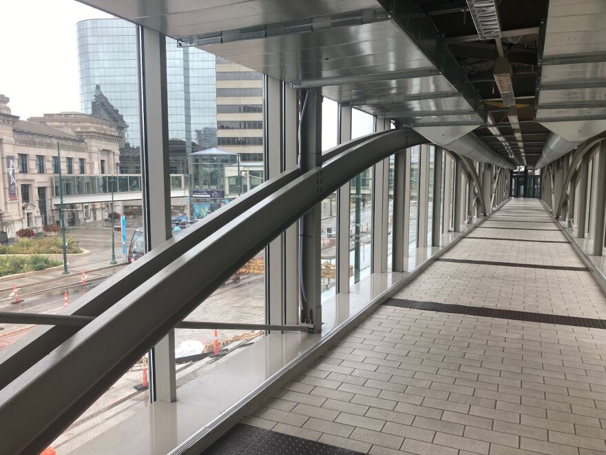 A glass and steel pedestrian bridge.