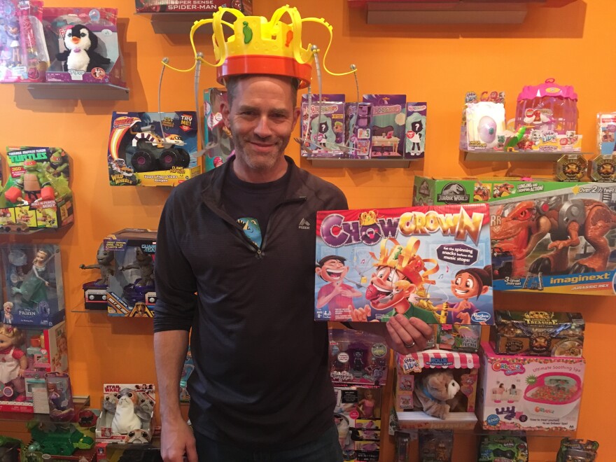 Bang Zoom Design Co-founder Mike Hoeting sports one of the holiday season's popular games - Chow Crown - in his Cincinnati showroom.