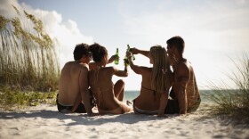 Drinking alcohol on beach.