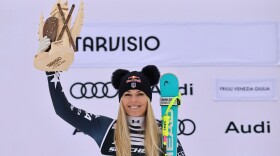 United States' Lindsey Vonn celebrates on the podium after taking second place in an alpine ski, women's World Cup Super G, in Tarvisio, Italy, Sunday, Jan. 18, 2026.