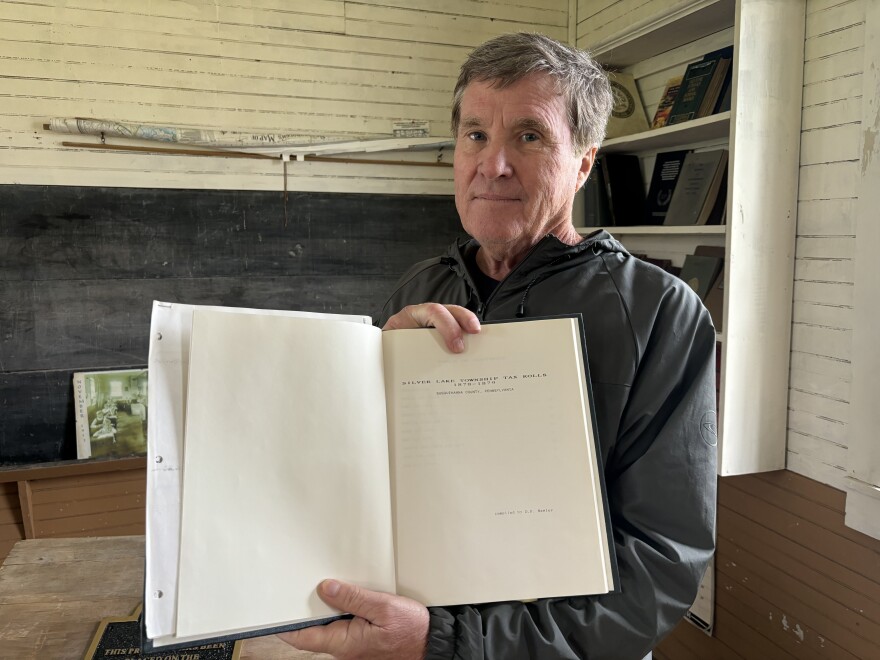 Daniel Hawley said he spent two years on getting the Richmond Hill School recognized by the National Register of Historic Places. He holds a book on Silver Lake's taxes from 1878-1879 compiled by his great-great uncle, who was a tax collector.