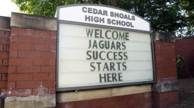 A brick sign outside Cedar Shoals High School reads, “Welcome Jaguars Success Starts Here.”