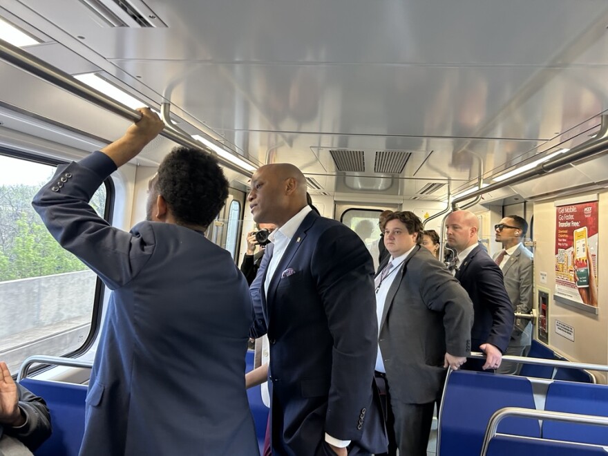Mayor Brandon Scott points out sights during a subway ride with Gov. Wes Moore.