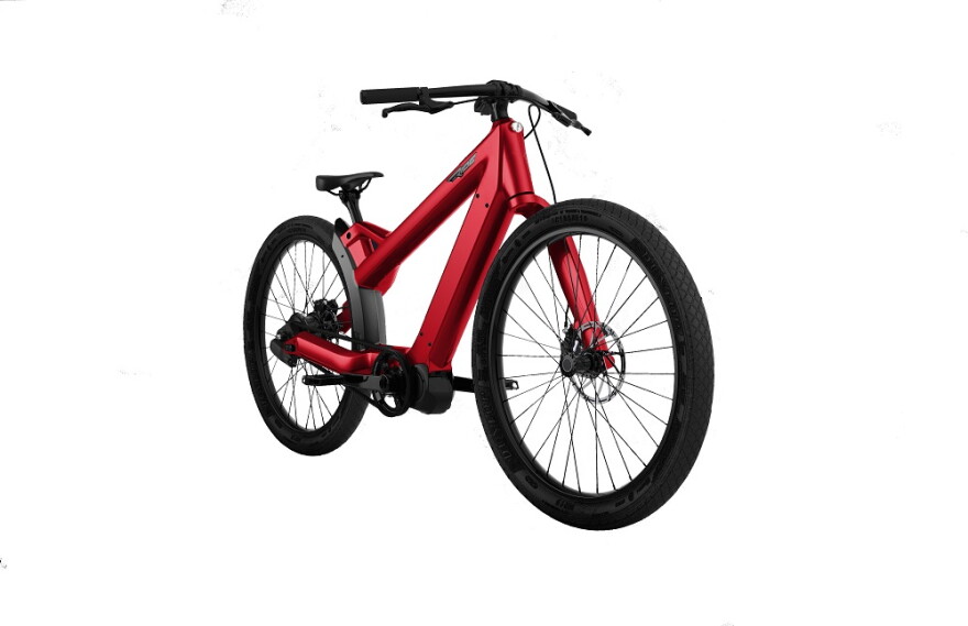 Red electric bicycle with step-through frame, integrated downtube battery, disc brakes, and wide tires, shown against a white background