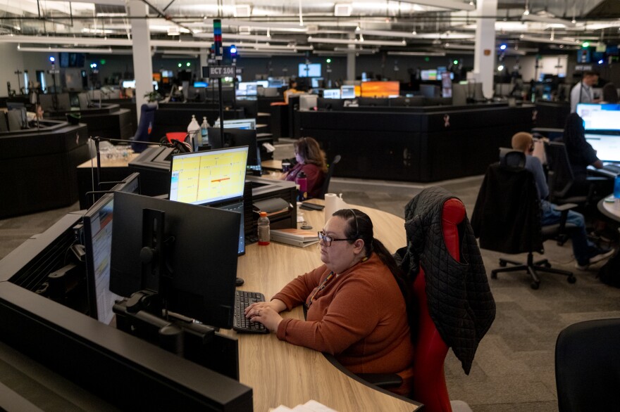 Silvia Morales, a bilingual emergency communications technician, works between calls at Denver 911.