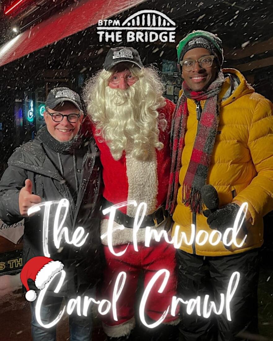 From left to right: Tom Calderone, "Santa", and Dallas Taylor outside on Elmwood for the BTPM The Bridge Carol Crawl, with snow falling. At the top center is a BTPM The Bridge logo and at the bottom reads THE ELMWOOD CAROL CRAWL with a Santa hat on the first C.