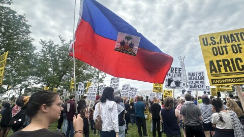 image, woman holding Haiti flag