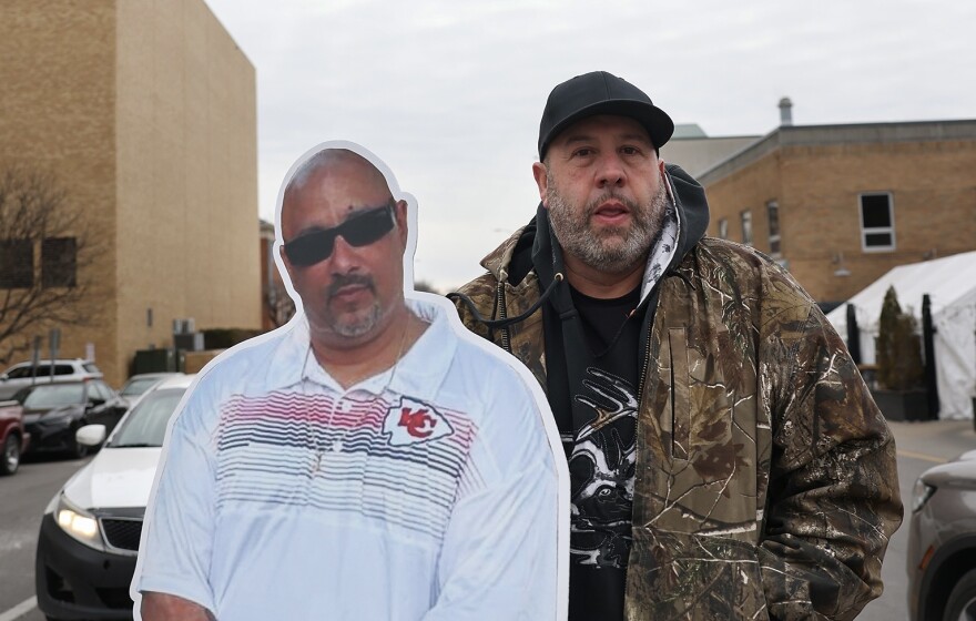 Robert Olson poses with a cardboard cutout of his friend Owen Ramsingh.