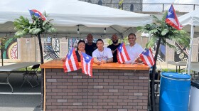 Organizers Priscilla Rivera of City Sports Bar (front left), Juan Uribe of El Paraiso Columbiano Restaurant, Melvin Sanchez of Bomba Radio, and Luis Rivera (back left) and Juan Montano of Fiesta Café, at Uribe's restaurant stand for Fiesta Patronales de Holyoke. 