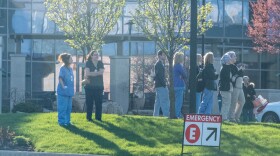 Early on in the pandemic, medical staff from Parkview Regional Medical Center stand outside for a first responder salute to their work with COVID patients.