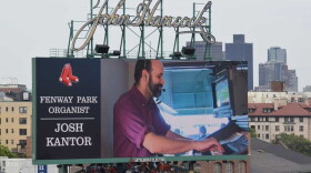 Organist Josh Kantor is projected on a large-scale electronic display at Fenway Park.