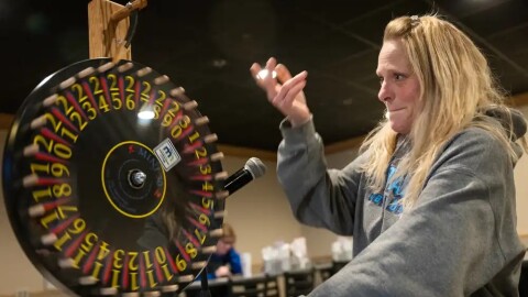 Raffle caller Heidi Heller spins the prize wheel during a meat raffle at the Hi-Stakes Cafe and Bar in Spring Lake Park, Minn., on Friday, March 27, 2026.