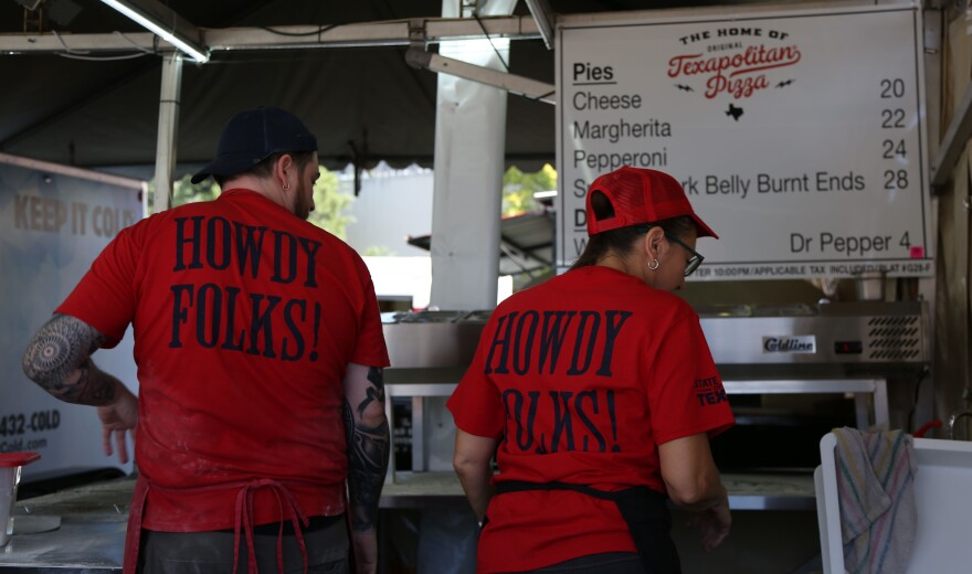 Texapolitan Pizza workers prepping food in their booth at the State Fair of Texas.