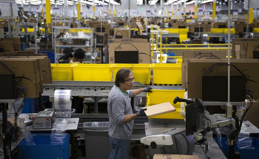 Amazon employee Filomeno Saya packages items at an Amazon fulfillment center on Friday, November 3, 2017, in Kent. 