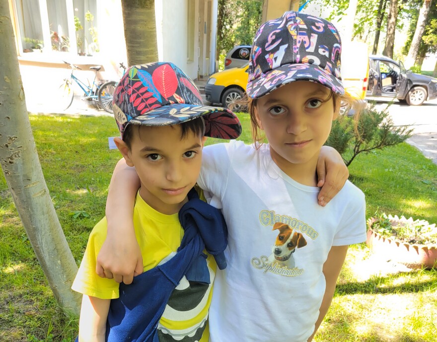 Olena (right), 11, and her little brother Zhenia, 9. They have not heard from their mother since the beginning of the war.