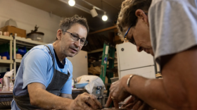 Keith Thomson helps customer Mary Sheldon form a bowl out of clay at the Firehouse Pottery & Gallery in Fort Worth on March 26, 2026. Thomson hosts classes where individuals can learn at a pottery wheel.