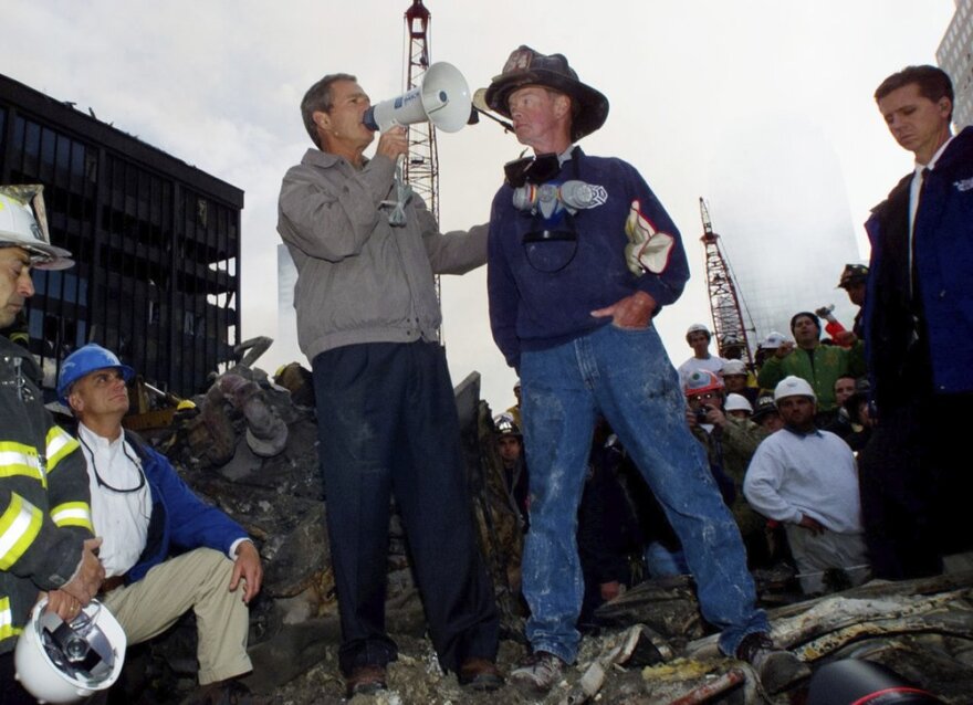 President George W. Bush addresses rescue workers through a bullhorn in the rubble of the World Trade Center in New York on Sept. 14, 2001.