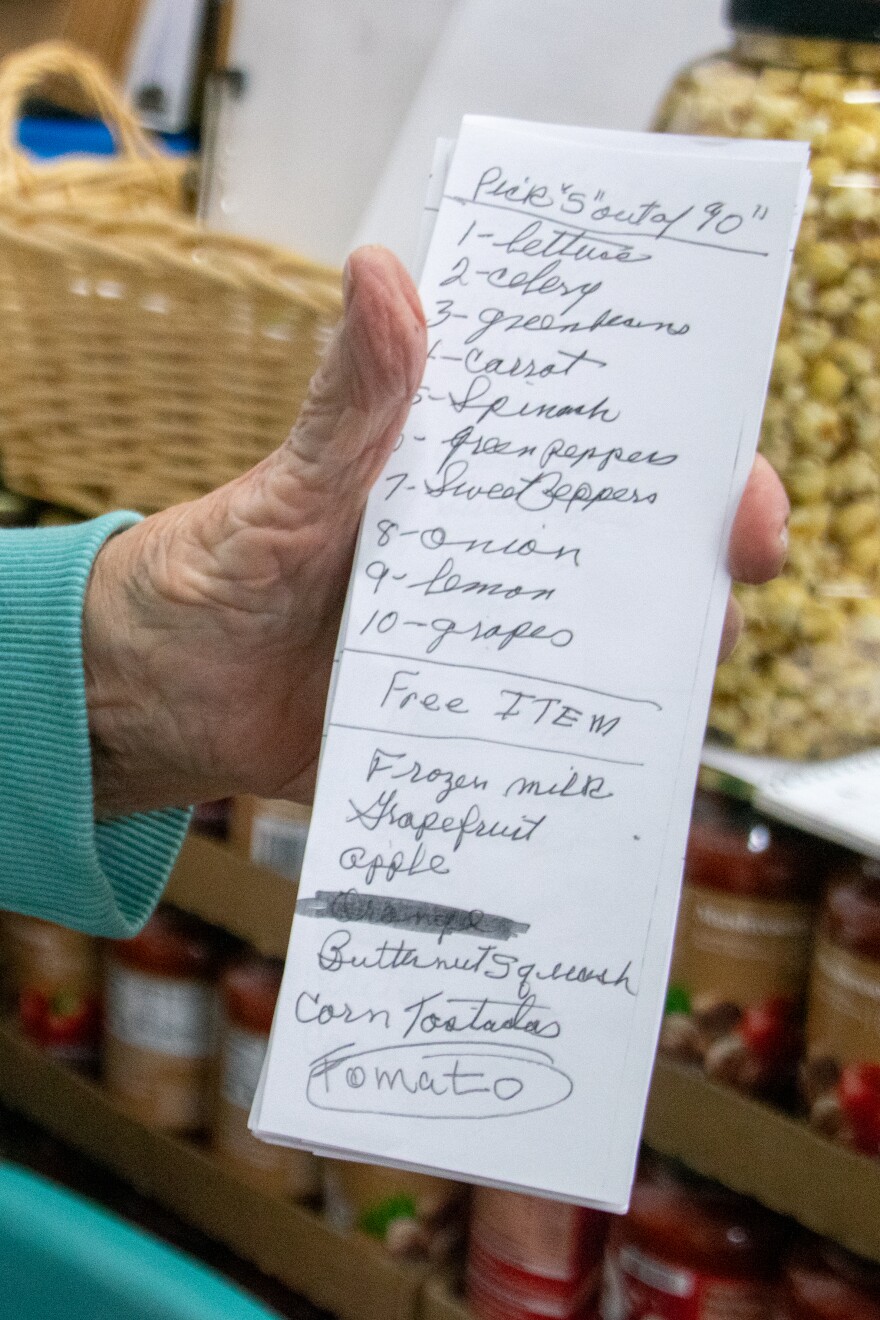 A look at the "menu" Bread of Life hands out to clients in their cars. They're able to pick five items from the top of the list and one free item from the bottom, which the volunteers then bag up and place in their cars.