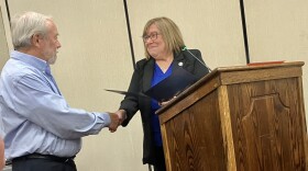 Mayor Lilija Stevens presents a proclamation to Washington resident Al Ponto that recognizes his heroic actions that alerted his neighbors to a fire at their home.