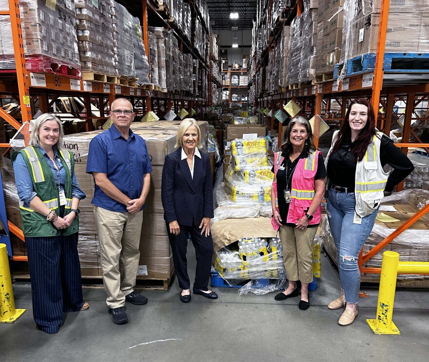 Anna McDermott of the Food Bank of Delaware, State Rep. Ed Osienski, Lt. Gov. Bethany Hall-Long, Food Bank of Delaware President and CEO Cathy Kanefsky and Megan Zavala of the Food Bank of Delaware in front of Hurricane Helene donations at the Food Bank of Delaware in Newark, Del.