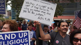 Protesters hold signs as they attend the 'Stand Up for Religious Freedom Rally', in front of the United States Courthouse on June 8, in Miami, Fla. Organizers voiced their opposition to Health and Human Services Mandate, which requires all employer-offered health insurance to cover contraceptives.