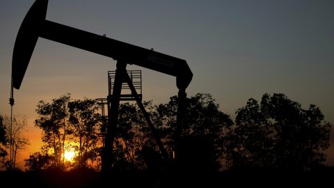 FILE - In this Feb. 19, 2015 file photo, the sun sets behind an oil well in a field near El Tigre, a town within Venezuela's Hugo Chavez oil belt, formally known as the Orinoco Belt. (AP Photo/Fernando Llano, File)